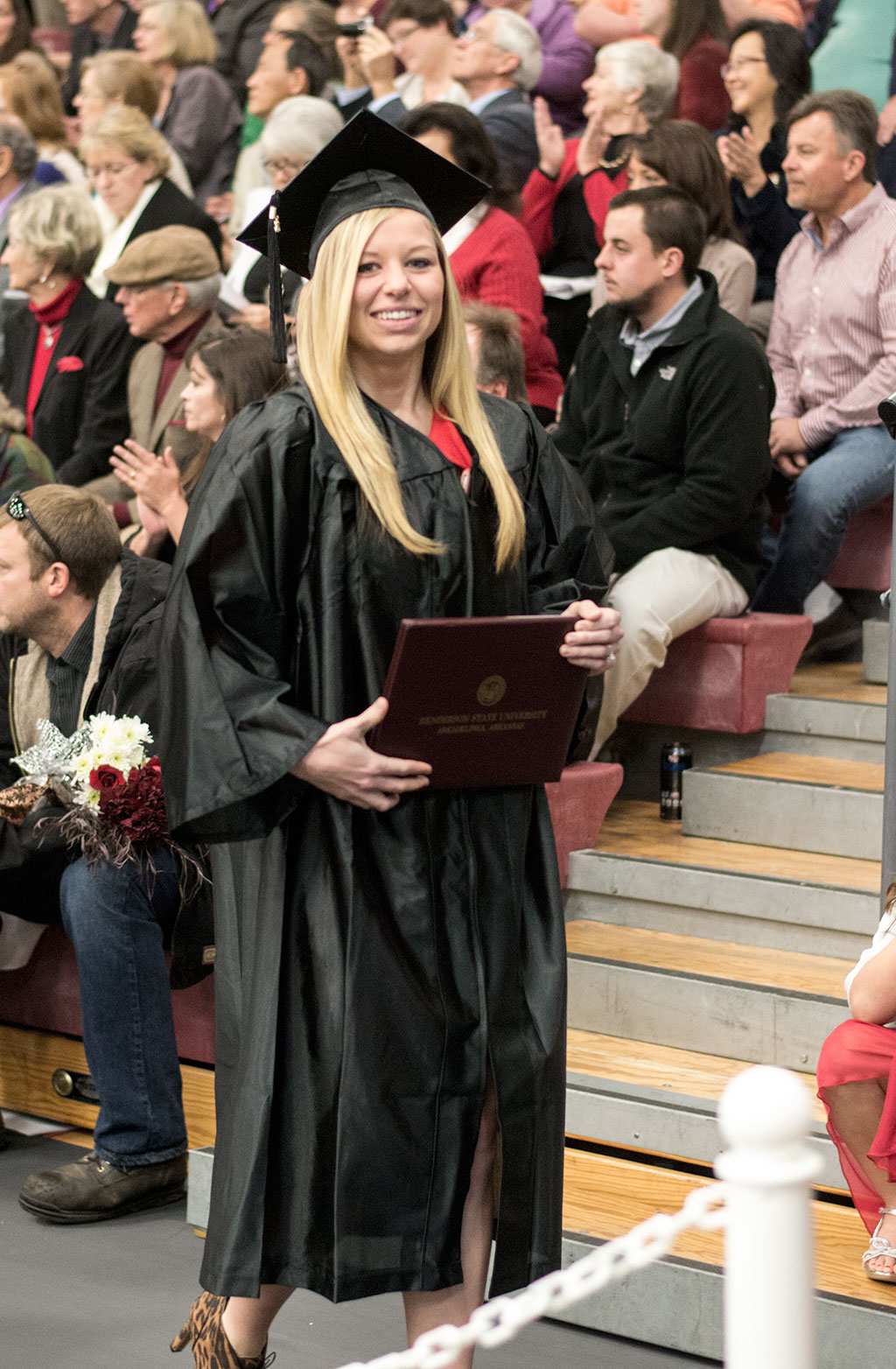 Jodi stands in line to have her portrait taken shortly after “walking” at HSU’s 2015 fall commencement ceremony on Dec. 18, 2015.